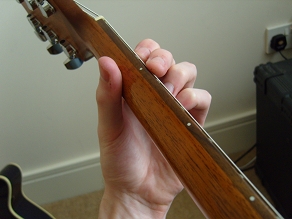holding the guitar neck - top view