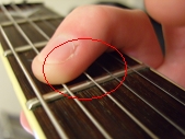 muting strings using index finger