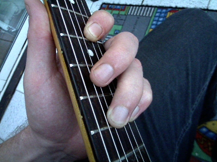 muting the 5th string using middle finger