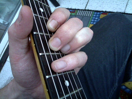 muting the 5th string using pinky finger