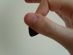 Holding the guitar pick - front view