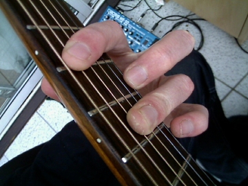 photo showing fingering for the A barre chord with barred 3rd finger