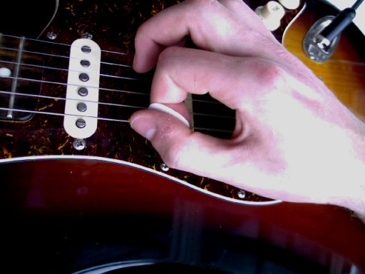 holding the pick at an angle to play faster