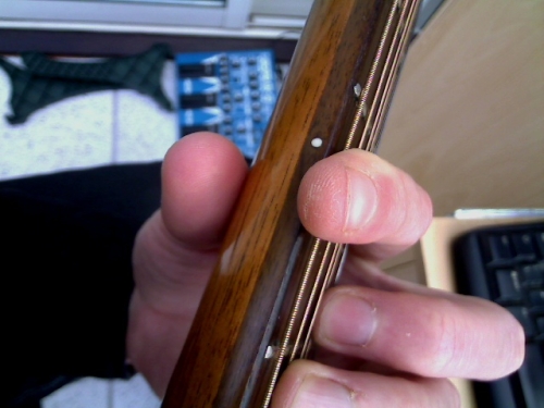 top view of thumb and index finger to increase strength when playing a barre chord