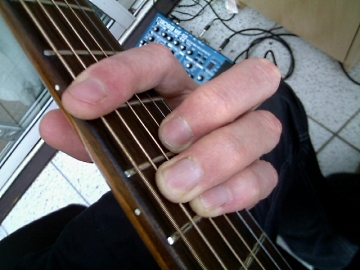 photo of E shape major barre chord from guitarist's POV