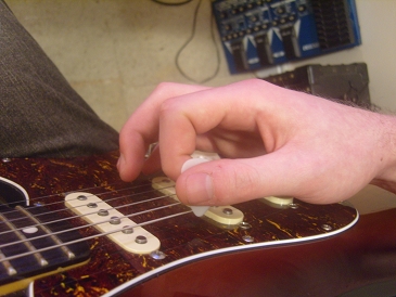 palm muting position with fret hand ready to pick