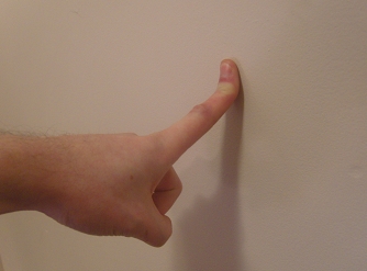 index finger stretched against a wall index finger stretched against a wall