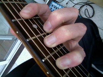 photo of C shape barre chord being fingered