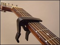 clamp style guitar capo attached to neck