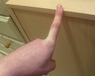 stretching the index finger against a desk