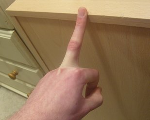 stretching the middle finger against a table