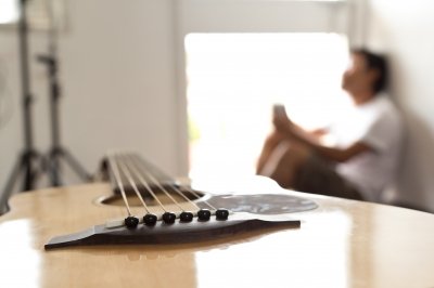 Man sitting away from his guitar